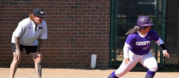 Knights softball player stands on a base during a game.